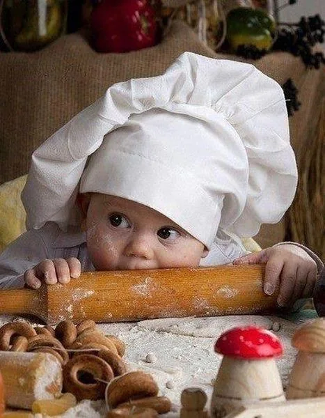 A Riverside baby exploring flour and a rolling pin