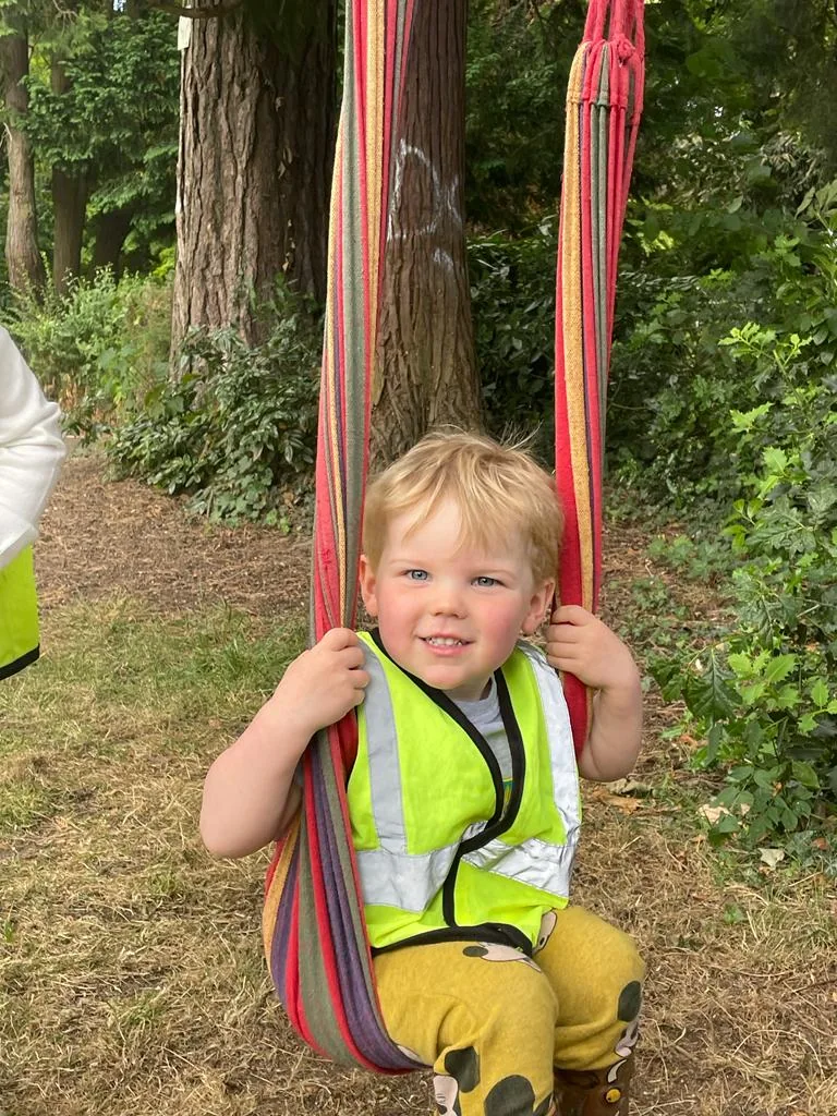 A smiling Riverside child playing in the garden